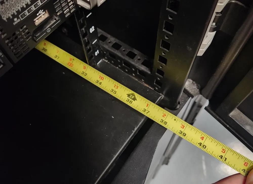 Photo of an extended tape measure inside my rack showing the usable measured depth at 36 inches.